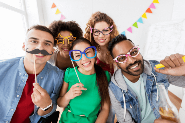 5 people with various face props enjoying in office