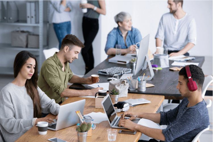 men and women working in office