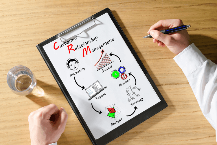man writing cycle of  Customer Relationship Management on white sheet