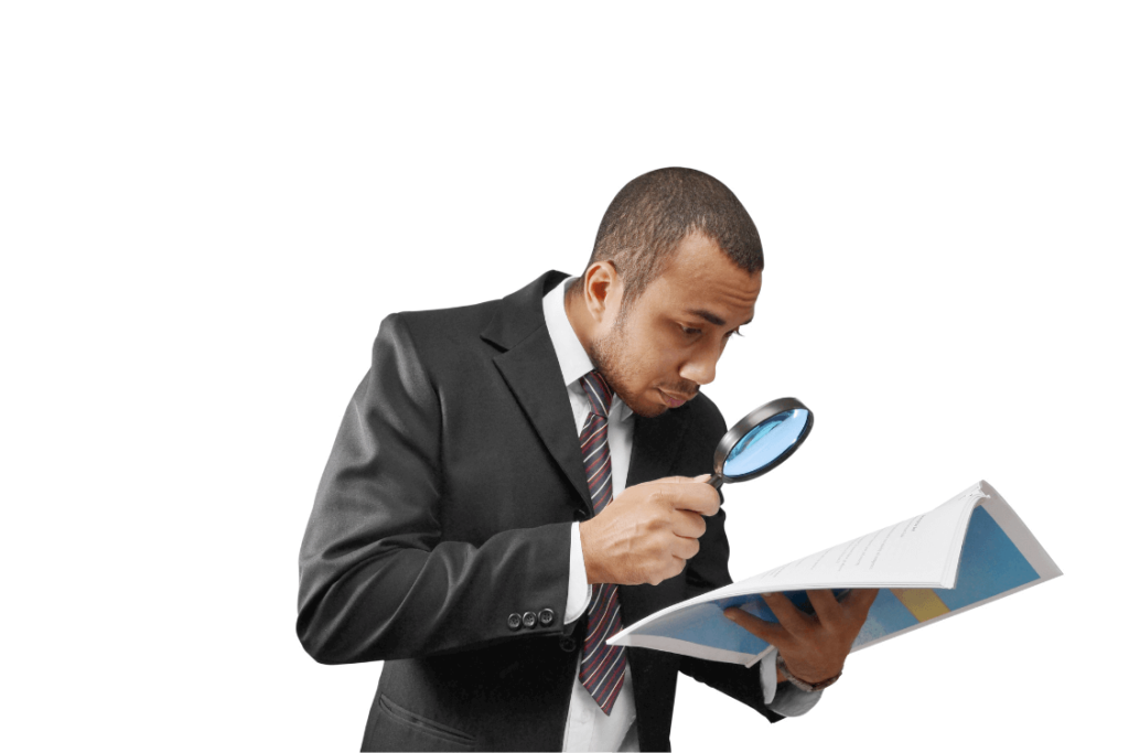 person looking with magnifying glass on reports file