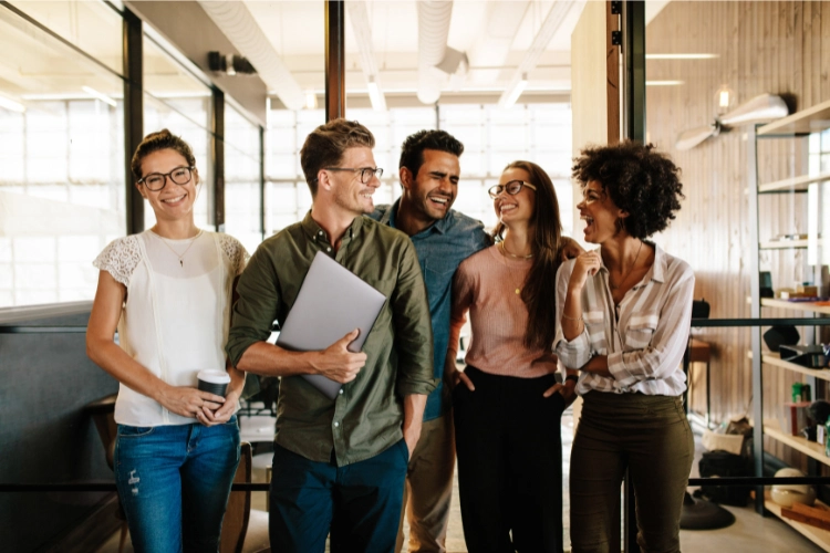 5 team members laughing, smiling