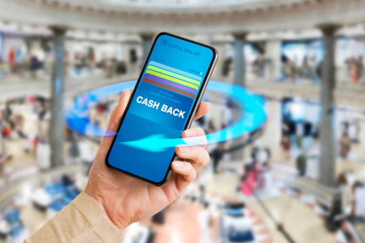 hands holding phone with digital wallet and cashback written on the screen