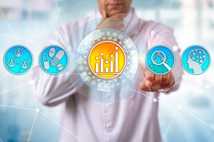 A person in a white lab coat interacts with futuristic icons representing graphs, pills, research, and a brain. 