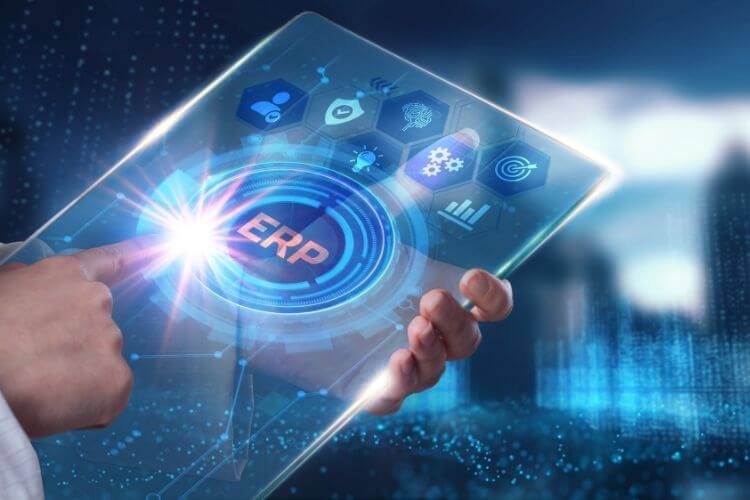 A person interacts with a transparent digital tablet displaying a glowing "ERP" interface