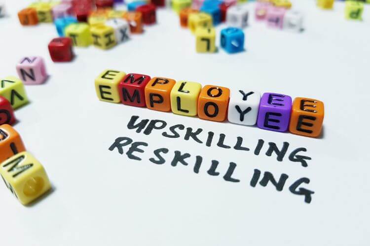 A colorful latter cube spell "EMPLOYEE" surrounding by scattered cubes.