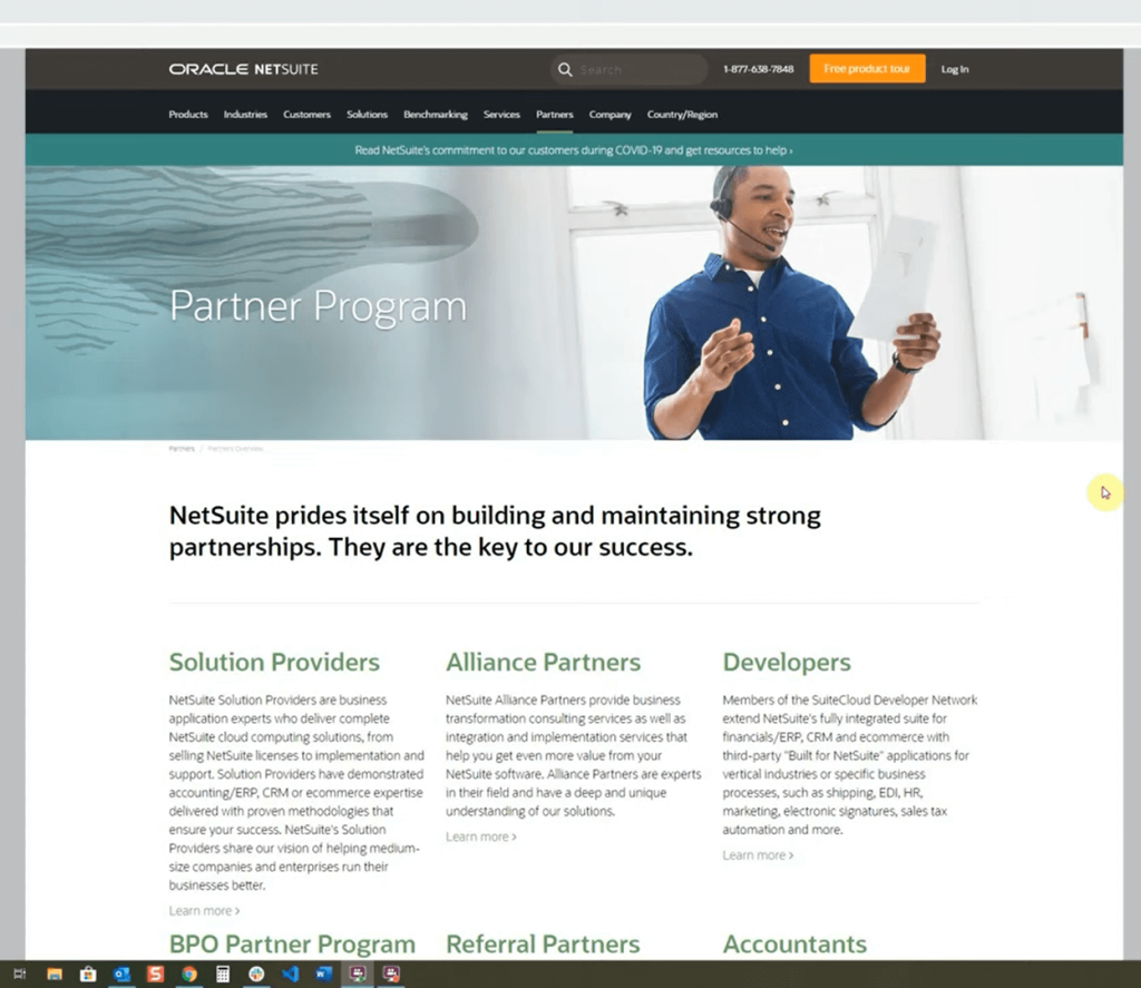 NetSuite webpage displaying "Partner Program" with a person speaking on a headset. 