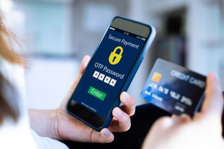 User entering OTP on mobile for secure credit card payment verification with two-factor authentication